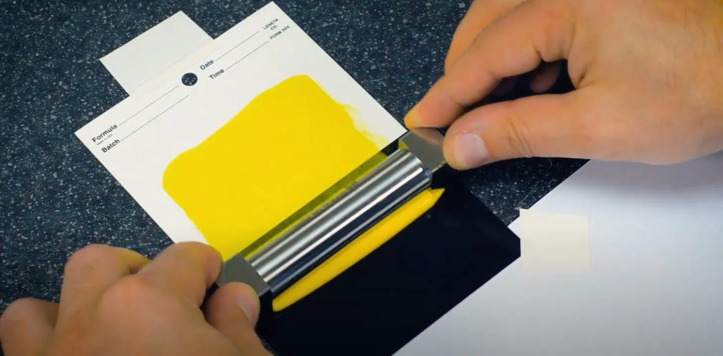 A thin film applicator spreading a polymer coating, screenshot from an Elcometer video